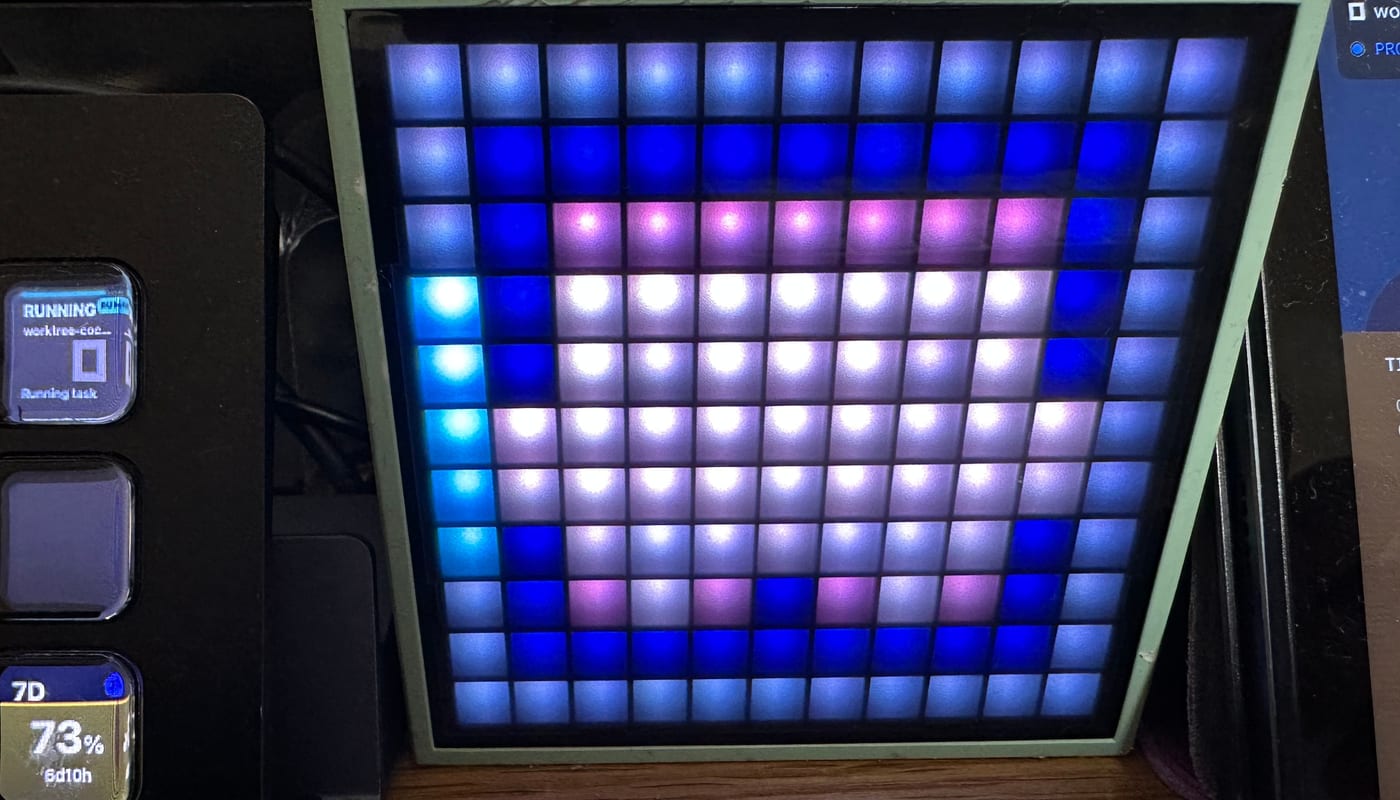 Divoom Timebox Mini showing an AgentDeck micro glyph